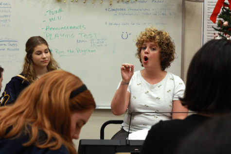 Vocal coach Tara Gillespie works with cast members for the high school version of Chicago. The coaches were brought in at the beginning of the year to assist students with music and dance for the musical, which opens on Thursday.