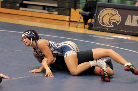 Junior Sophia Rivera dominates her opponent and looks up to her coach for her next move to finish the match against an opponent from Lanier High School in January. Rivera, who has been wrestling since her freshmen year had a 44-12 record this year and competed at the state level.
