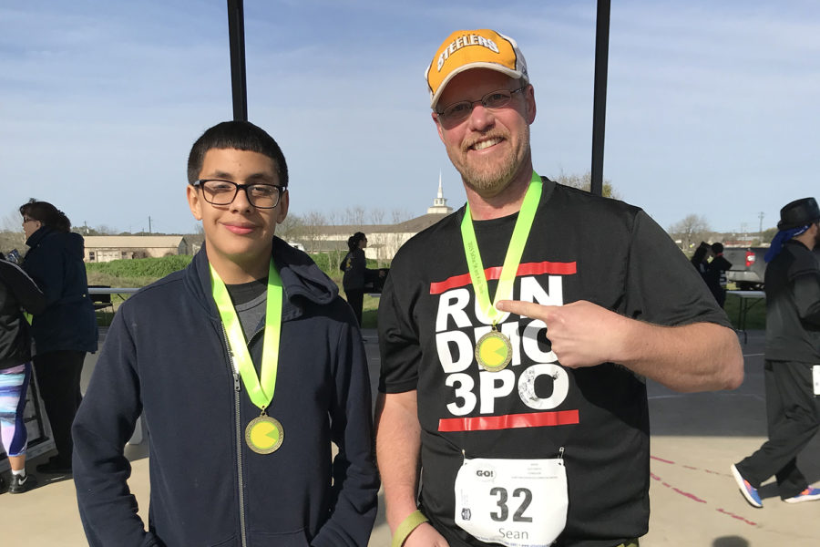 Yearbook+teacher+Sean+Claes+congratulates+freshman+Jordyn+Aguilar+for+beating+his+time+in+the+SoChac+5K+race.+Claes+boasted+that+he+was+the+Fastest+Person+at+Akins+to+encourage+Akins+staff+and+students+to+participate+in+the+race%2C+which+benefits+Akins+High%2C+Paredes+Middle+and+Menchaca+Elementary+schools.