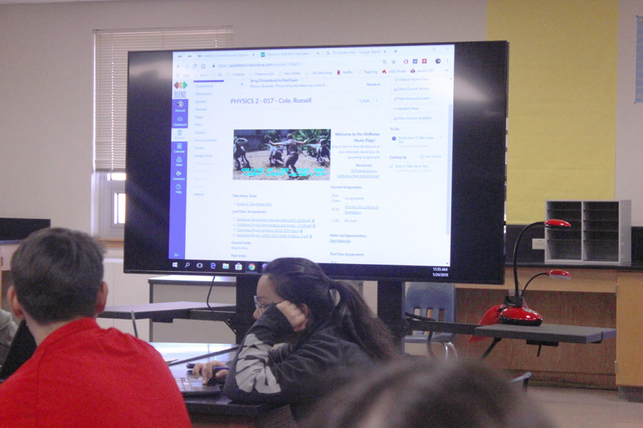 Students watch as a physics teacher uses his EduDisplay to guide students through a daily assignment. The TVs arrived in classrooms in January.