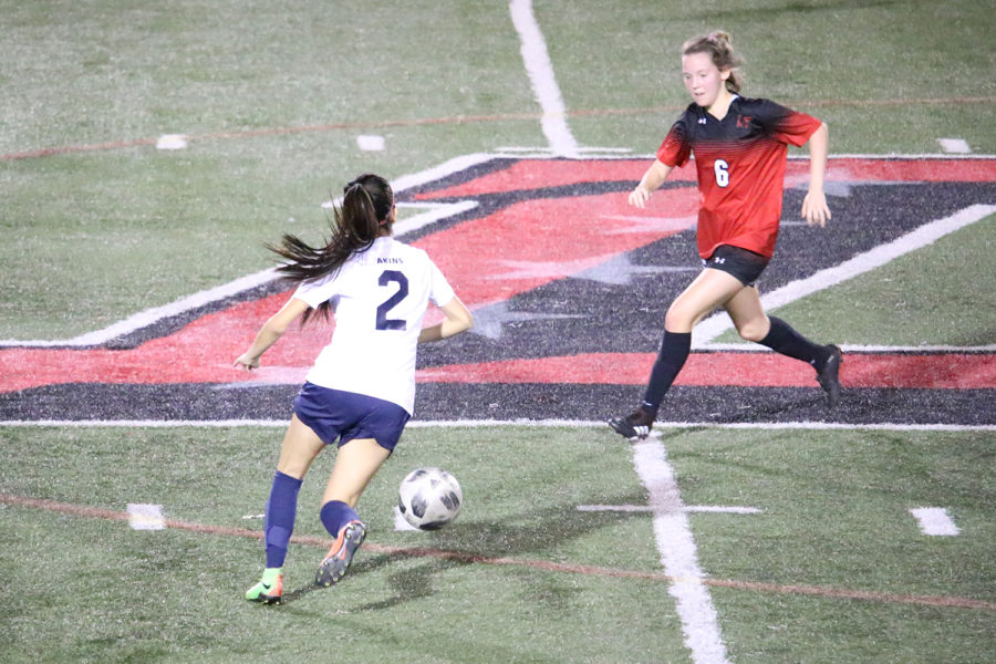 Sophomore Alex Castillo dribbles the ball on the field against their opponent Lake Travis, which defeated Akins 10-0. Coach LeVon Griffin said he is looking for the team to make improvements that the players can make from game to game.