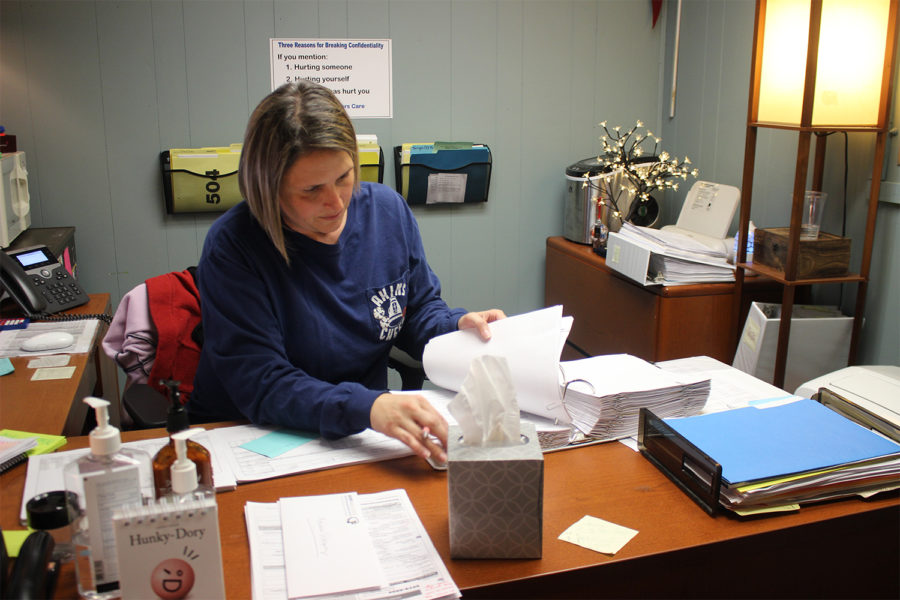Jacey Saylor-Carroll, counselor for the Social Services Academy, reviews paperwork she uses to keep track of student progress. All Akins counselors struggle with caseloads above the ratios recommended by the American School Counselor Association.