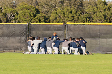 Senior Julian Smith gives the team a pre-game pep-talk. The team also says a prayer to boost morale.