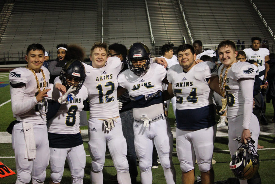 Senior varsity football players celebrate after their last football game together.