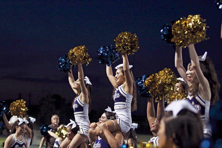 Junior Marrissa Almaraz (center) Cheer Captain and the rest of the cheer team energize the crowd at the Akins Homecoming game. The cheer program welcomed new Coach Jordyn Marsh this year.