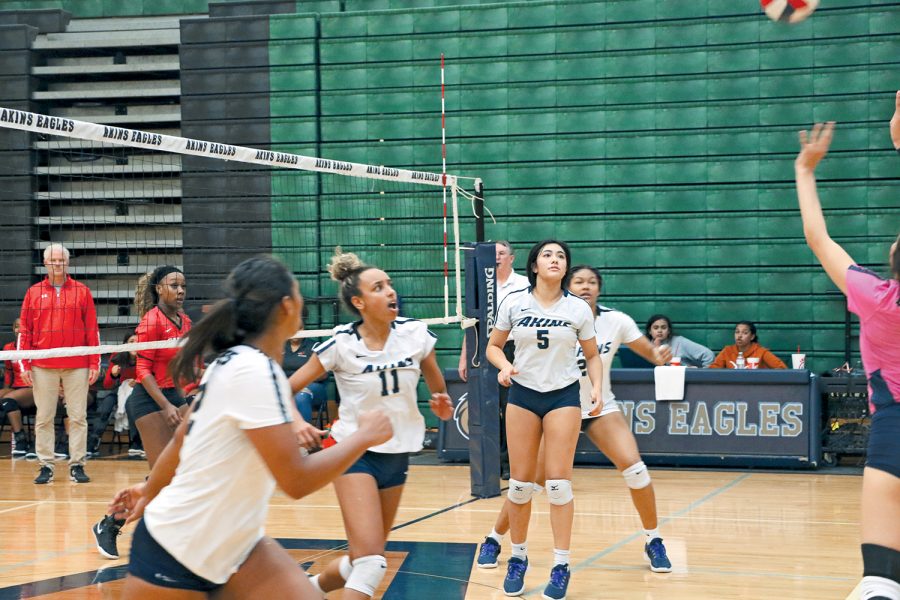 Seniors Zola Schemenauer-Moore (11) and Kayla Muñoz (5) move to play a ball in mid air. They played their final game as Eagles against Del Valle.