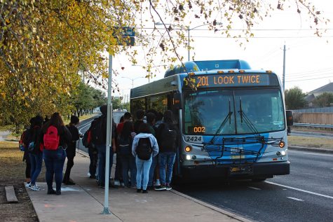 Akins students board a city bus after school at the bus stop on First Street. Capital Metro bus service is one of many option students use to get around town without a car.