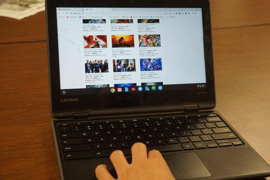 A student browses a website with pirated streamable movies on a Chromebook.