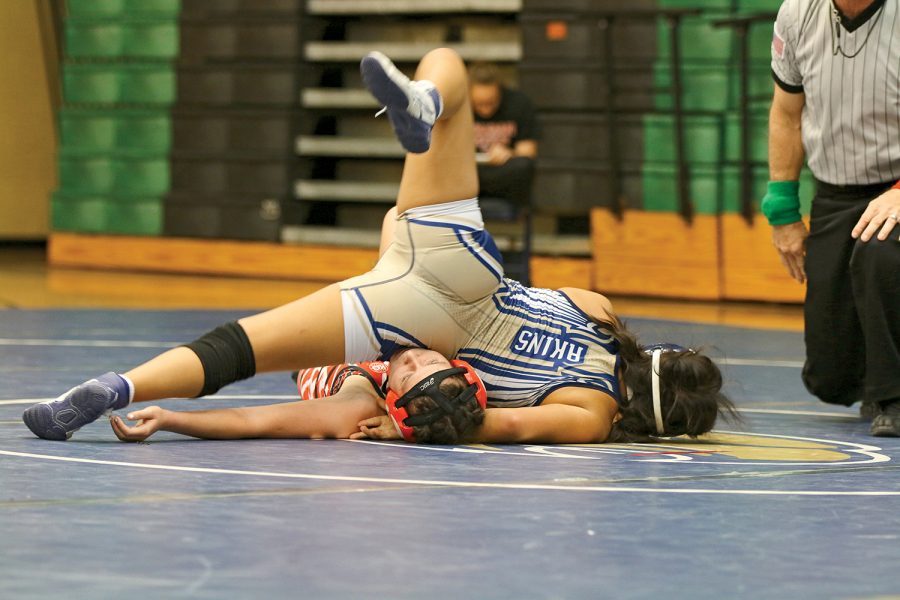 Leila Gomez uses her body weight to pin down her opponent.