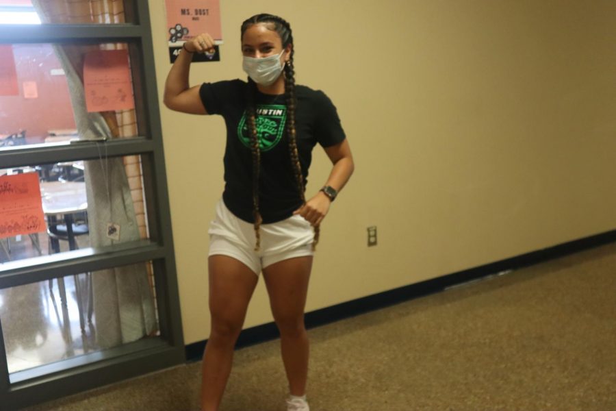 Senior Ana Claudia flexing in the STEM hallway. 