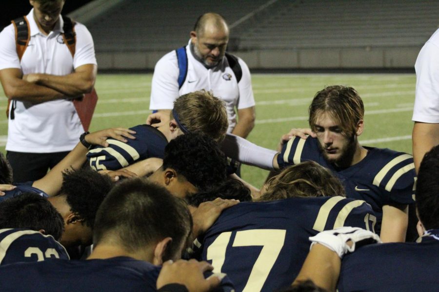 Akins players unite with their coaches after a successful game on Homecoming night.