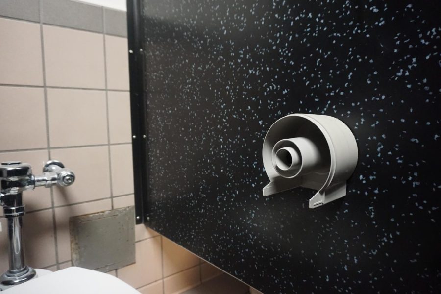 Toilet paper is missing from the holder in a girls bathroom. Toilet paper has been intentionally removed by vandals in several bathrooms at Akins in association with the Devious Licks TikTok trend.