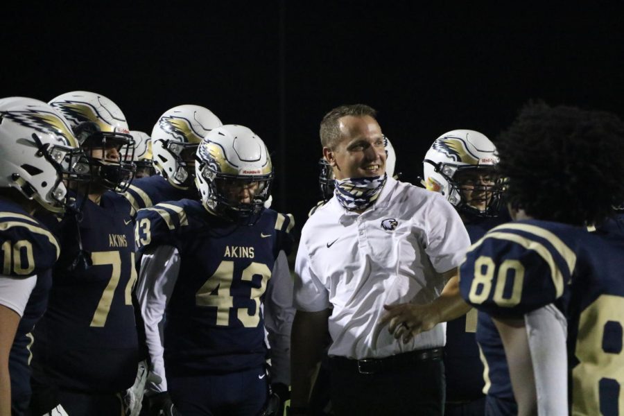 Coach Saxe with football players during the Homecoming game. 