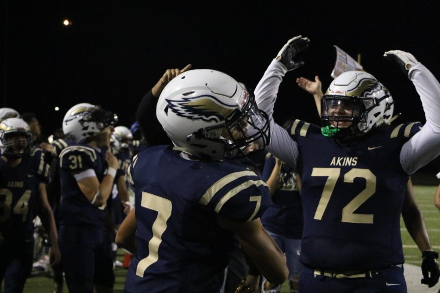 Akins players celebrate their win from the Homecoming game. 