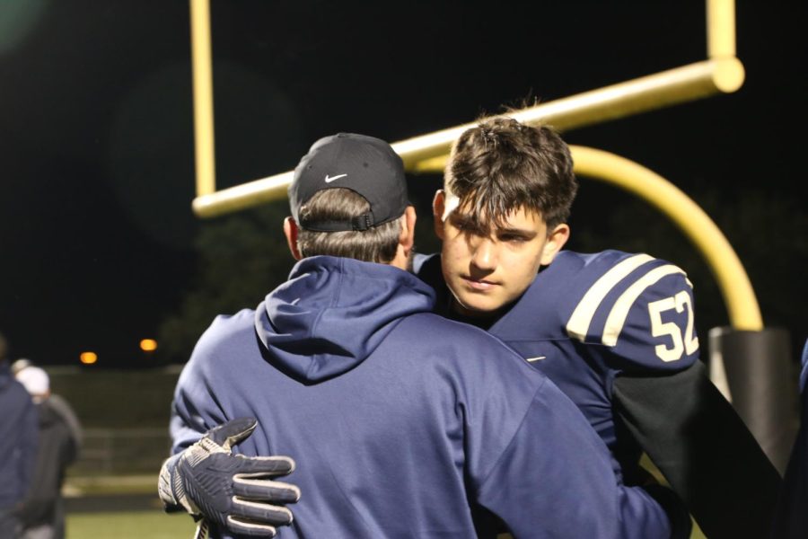 Senior+lineman+Carlos+Soria+gives+defense+coach+Gordon+Taylor+a+hug+after+the+Senior+Field+Walk+after+the+loss+against+San+Marcos+Rattlers.