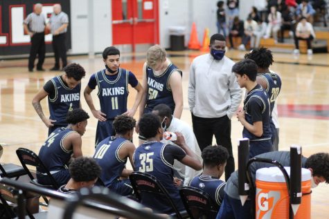 Akins Boys Varsity huddles to come up with some changes to try and regain the lead over the Del Valle Cardinals during a game in January.