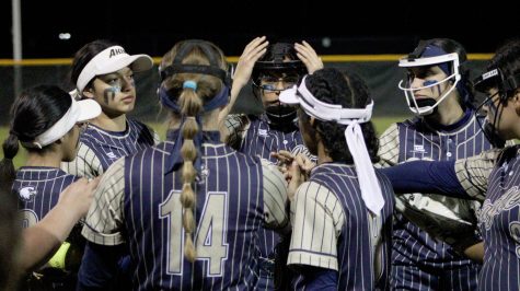 The Akins Softball team starts their first game against Hays High School Hawks with a huddle.