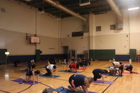 Morgan Eddy leads students through a yoga and meditation sequence. The yoga program has grown to more than 160 students.