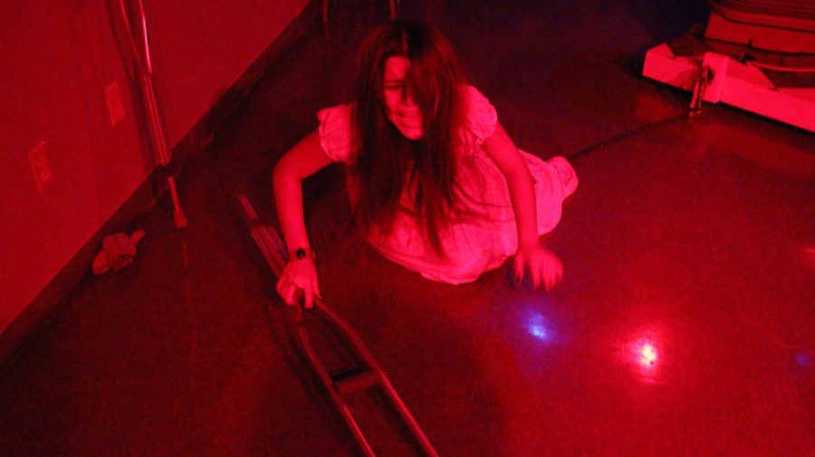 A student actor performs one of their roles in the haunted house.