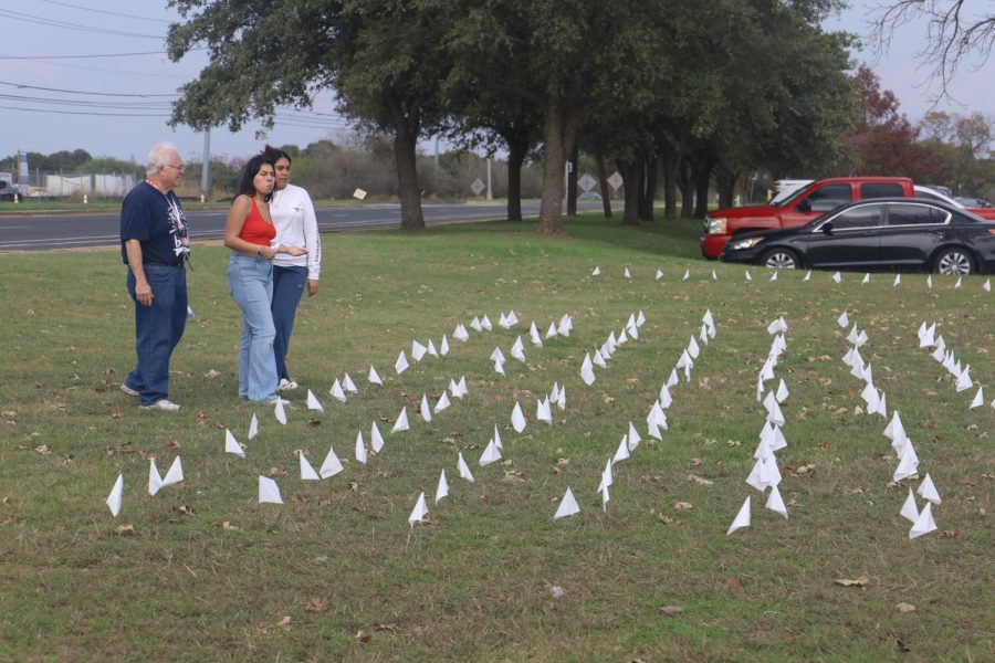 Students+Crystal+Castillo+and+Kayla+Zamora-Nu%C3%B1ez+place+392+white+flags+at+the+front+of+the+school+to+create+a+memorial+representing+the+lives+lost+to+school+shootings+since+the+1999+Columbine+shooting.