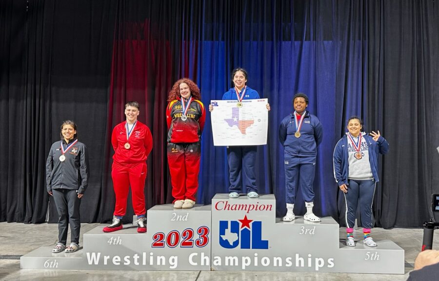 Deonne Topete stands on the winners podium after placing fifth at the state-level University Interscholastic League wrestling tournament.
