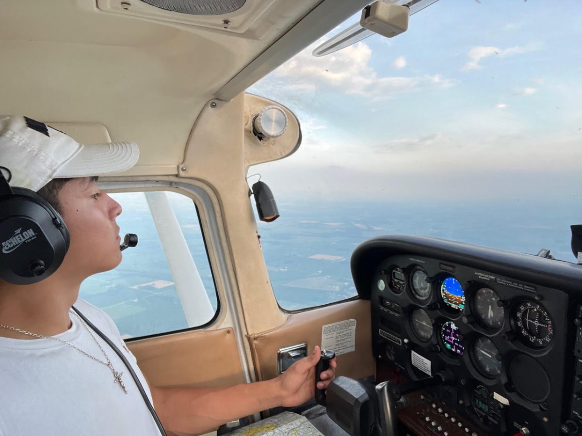 Senior Hector Hernandez pilots a single-engine plane as part of his 8-week summer training over Shelbyville Airport in Indiana. 
