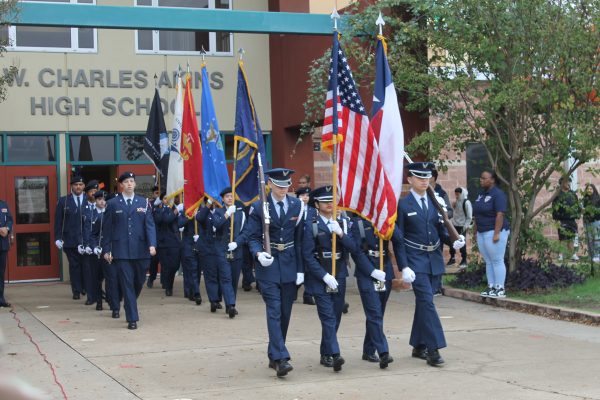 Akins JROTC marches to the Veterans Day Ceremony held at the school entrance on Nov. 10.