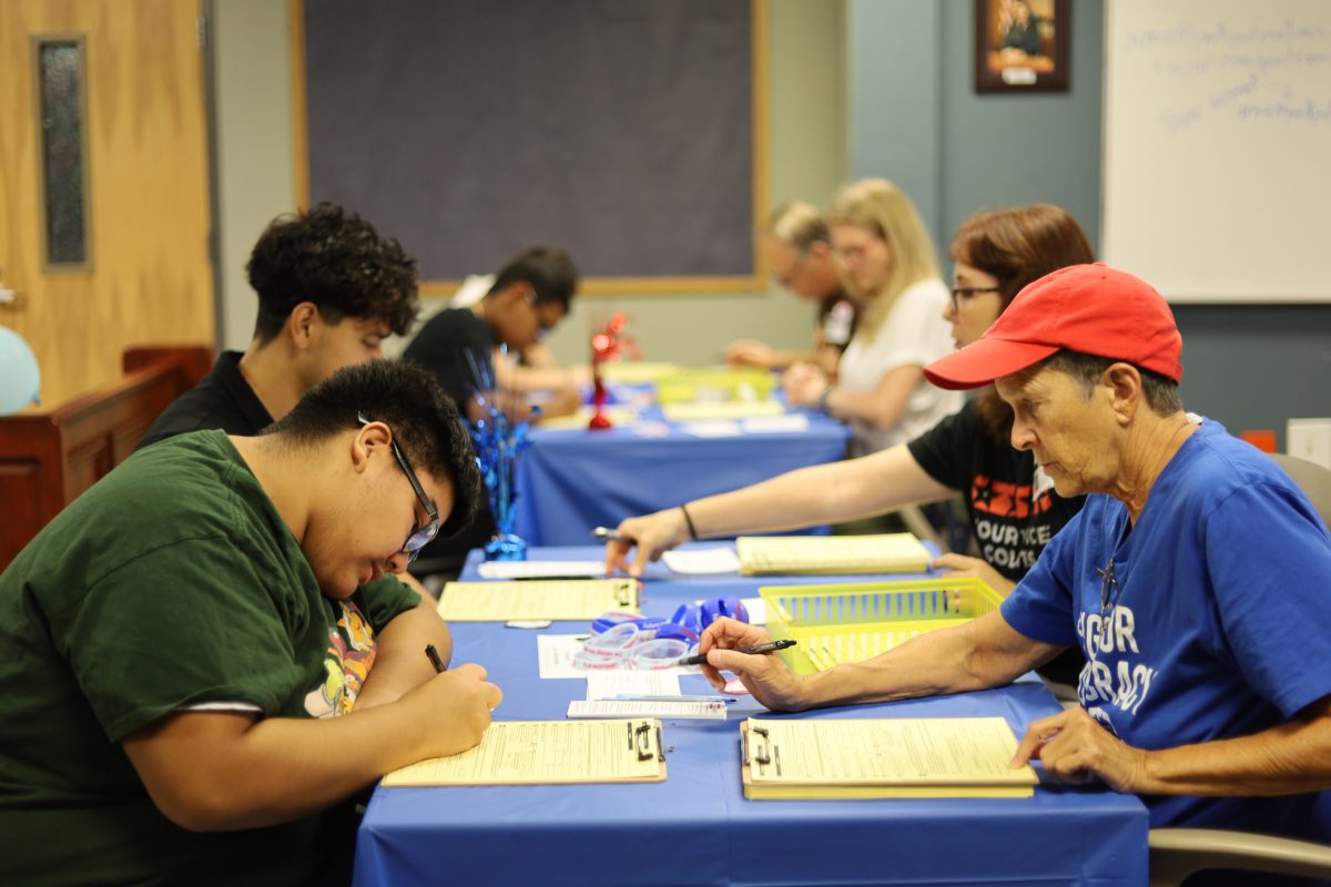 Students complete forms to become registered voters on Sept. 17 as part of National Voter Registration Day. Students must be 18 before Nov. 5, which is Election Day to be an eligible voter.