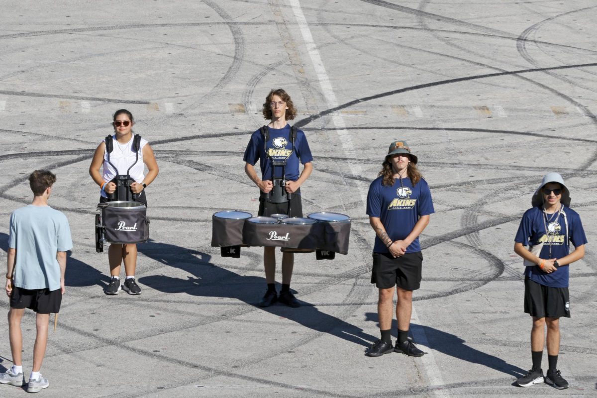Members of the Akins Marching Band practice early Saturday morning before the Capital City Band competition. During the Fall, between the football games,  school events,  and competitions,  they continuously prevail through the seemingly never ending season.