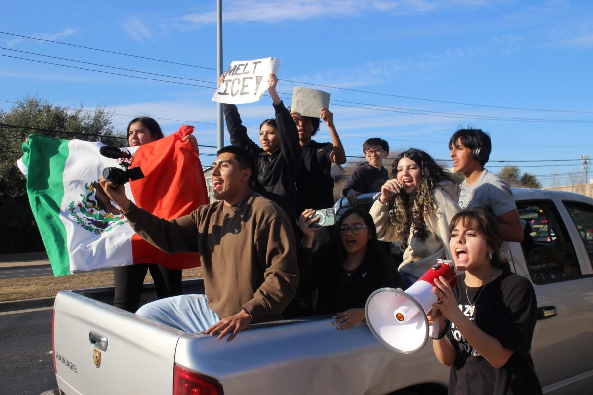 Protest organizer Adeleah Cardenas with megaphone and a group of Akins sudents.