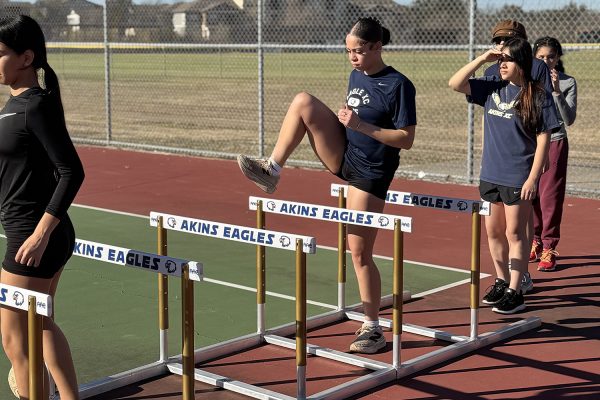 Senior Amaya Jolivette practices her stride over during hurdles
drills held on the tennis courts as a temporary training area. The
track team has not had access to their regular track during the
current school year because of construction delays for the bond
projecy to rebuild the Akins practice track and field.