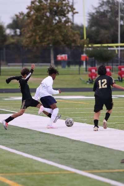 Senior Jayvon Suazo is dribbles past crockett players during Copa Akins Tournament in January.